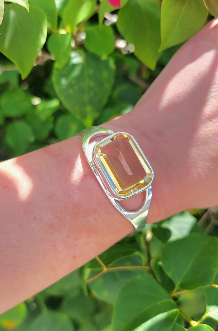 Simplicity 61.5 carat Genuine Lemon Quartz handcrafted .925 Sterling Silver Bracelet / Cuff - Lemon Quartz bracelet worn on wrist in sunlight, leafy background.