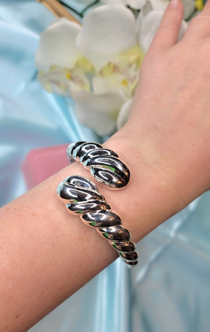 Italy made Bracelet in best quality highly polished .925 Sterling Silver - Bracelet worn on wrist, twisted design, shiny .925 silver, close-up view.