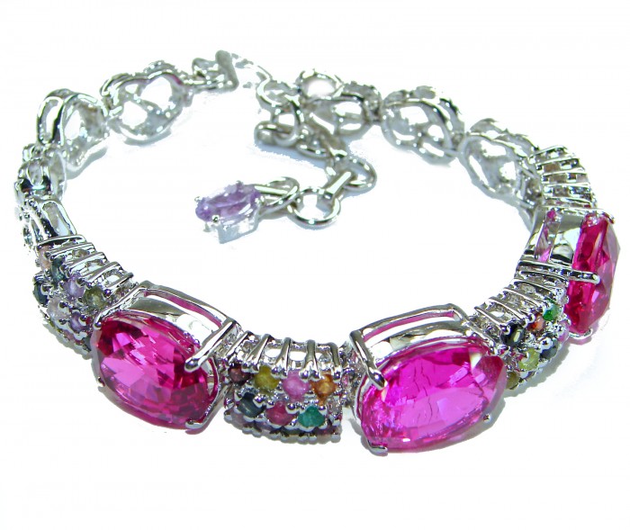 Tiffany - Unapologetically stunning Fuchsia Pink 125.5 carat Pink Sapphire RHODIUM OVER .925 Sterling Silver handcrafted Heavy Bracelet - Bracelet with fuchsia stones and clasp detail, angle view.