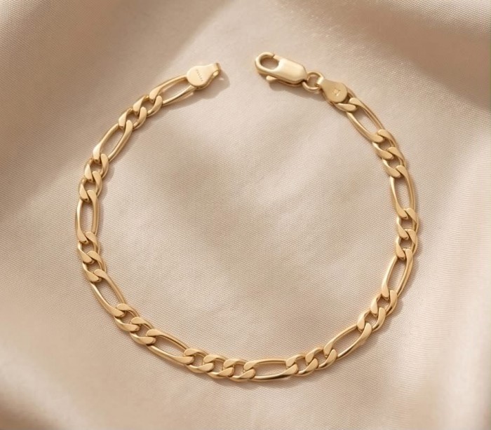 Authentic Figaro design 18K Gold over .925 Sterling Silver handmade Bracelet - 18K gold Figaro bracelet on fabric, showcasing clasp and chain detail.