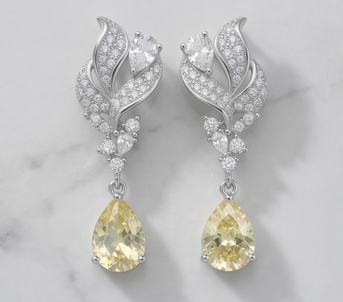 Luxurious 4.5 carat Golden - yellow Montana Sapphire .925 Sterling Silver handcrafted earrings - Elegant earrings with yellow sapphires and diamond accents, front view.
