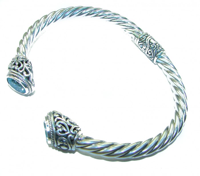 BLUE DREAMER 8.5 carat authentic Swiss Blue Topaz Floral Bracelet in .925 Sterling Silver - Silver bracelet with blue topaz and floral detail, angled view.