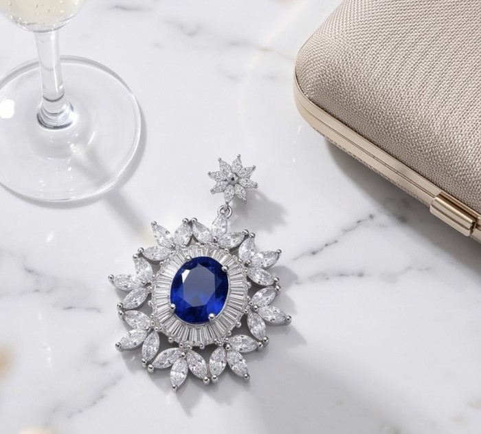 Born to Glam 4.2 carat natural Sapphire .925 Sterling Silver Perfectly handcrafted Pendant - Top view of sapphire pendant with glass and clutch on marble surface