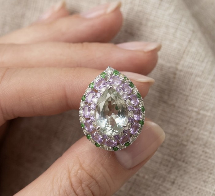 Large Natural 18.5 carat carved Green Amethyst rhodium over .925 Sterling Silver handcrafted ring size 6 3/4 - Close-up of large green amethyst ring held between fingers