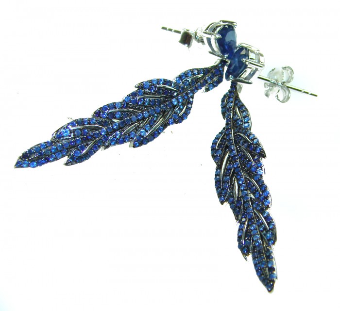 Giovanna - Authentic oval cut 9.9 carat Sapphire .925 Sterling Silver handcrafted earrings - Blue sapphire feather earrings on white background, side view.