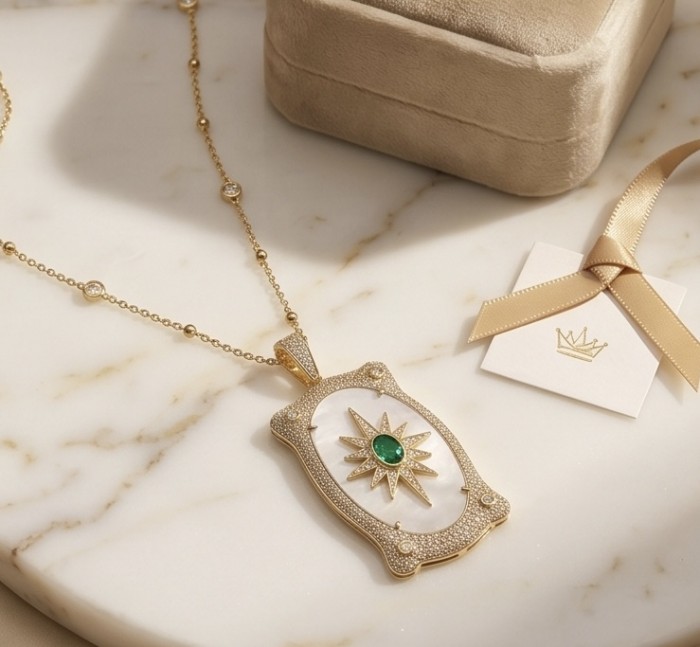 Precious Blister Pearl 2.4 carat Emerald 18K Gold over .925 Sterling Silver .925 Sterling Silver Necklace; 24 inches long - Gold necklace with emerald and pearl, top view on marble surface.