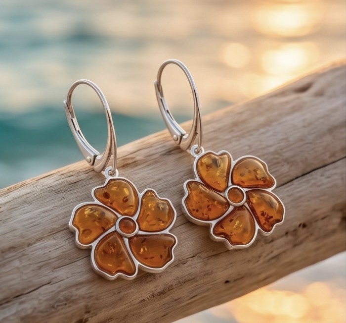 Serenity - Authentic Baltic Amber .925 Sterling Silver handcrafted earrings - Flower-shaped Baltic amber earrings, side view on wooden background.