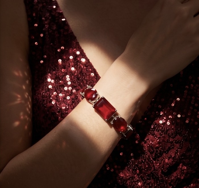 Bella Rosa - Magnificent 152.4 carat authentic Ruby .925 Sterling Silver handcrafted Bracelet - Worn on wrist, ruby bracelet, red sequin dress backdrop.