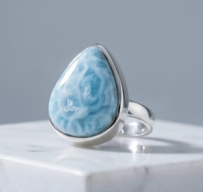 Rare and Spectacular 2259 carat authentic Andean (Peruvian) Blue Opal .925 Sterling Silver Handcrafted Ring size 8 - Close-up of a silver ring with a large blue stone on a marble surface.