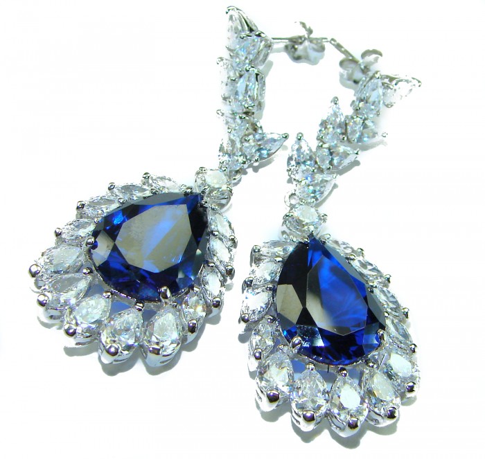Giovanna - Authentic pear cut 22.9 carat Sapphire .925 Sterling Silver handcrafted earrings - Close-up of earrings with pear-cut sapphire and surrounding clear stones.