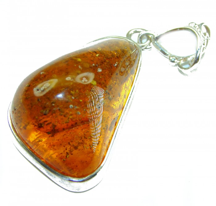 Prehistoric Authentic Golden Baltic Amber .925 Sterling Silver beautifully handcrafted Pendant - Close-up of golden Baltic amber pendant with sterling silver setting