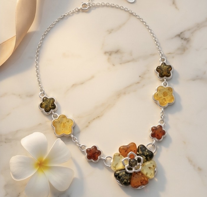 Floral design - natural multicolor Baltic Amber .925 Sterling Silver handcrafted necklace - Floral necklace with multicolor Baltic amber, top view on marble surface.