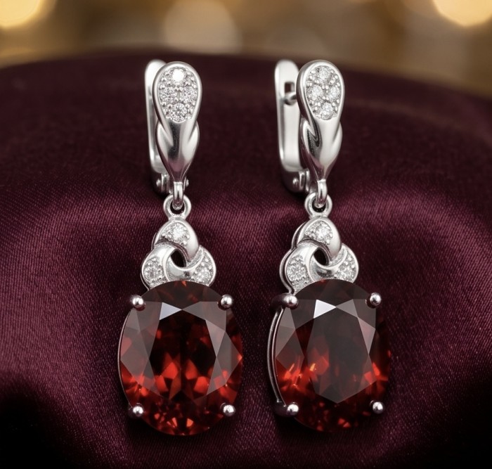 Magnificent Jewel 10.5 carat Ruby .925 Sterling Silver handcrafted incredible earrings - Elegant ruby and sterling silver earrings on a rich burgundy fabric background.