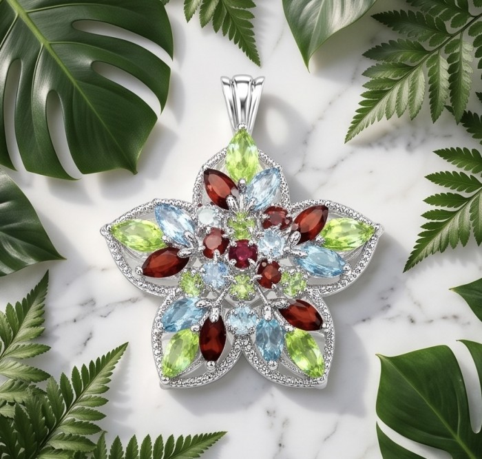 Colors of the Earth Precious 24.5 carat Multigem .925 Sterling Silver dipped in rhodium Pendant - Top view of multigem flower pendant with green leaves background