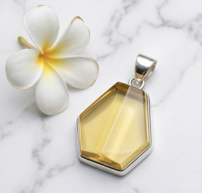 Prehistoric Authentic faceted Golden Baltic Amber .925 Sterling Silver beautifully handcrafted Pendant - Faceted golden Baltic amber pendant, top view with plumeria flower.