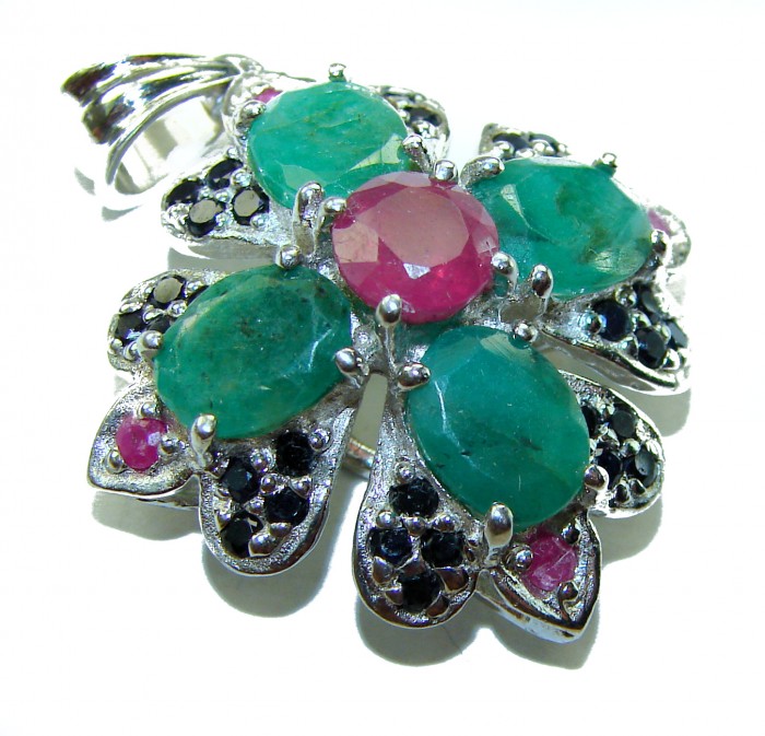 Spectacular 28.8 carat authentic Colombian Emerald .925 Sterling Silver handcrafted Pendant - Emerald flower pendant with ruby center, top view.