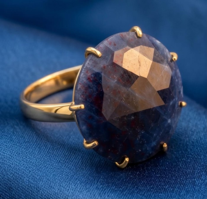 Born to Glam 14.2 carat natural Sapphire 18K Gold over .925 Sterling Silver Perfectly handcrafted Ring s. 8 - Close-up of 14.2 carat Sapphire ring, 18K gold setting on blue fabric.