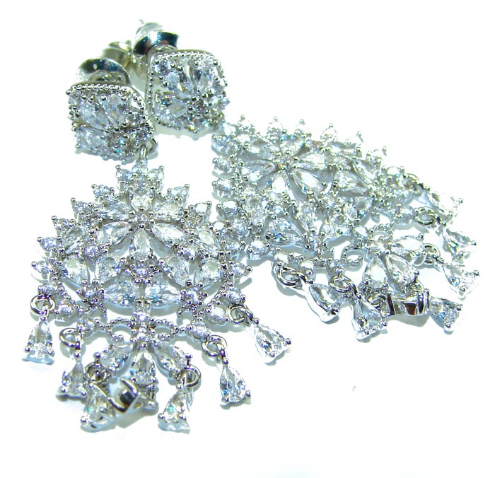 Precious genuine 11.9 carat White Topaz .925 Sterling Silver handcrafted earrings - White Topaz earrings, top view on white background, intricate detail.