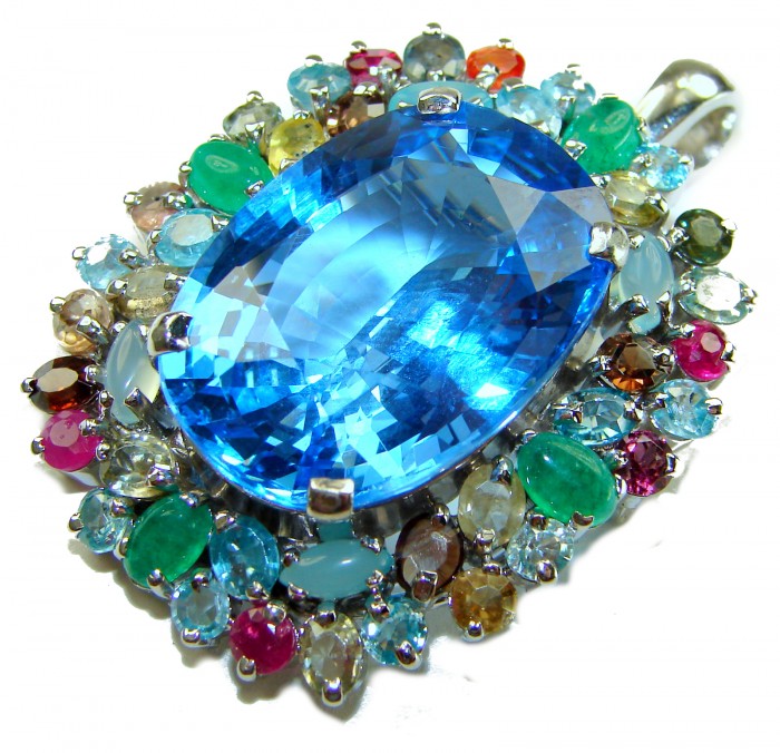 Oceania oval cut 32.8 carat Swiss Blue Topaz .925 Sterling Silver dipped in rhodium Handcrafted Pendant Brooch - Close-up of Oceania oval Swiss Blue Topaz with colorful gemstone accents.