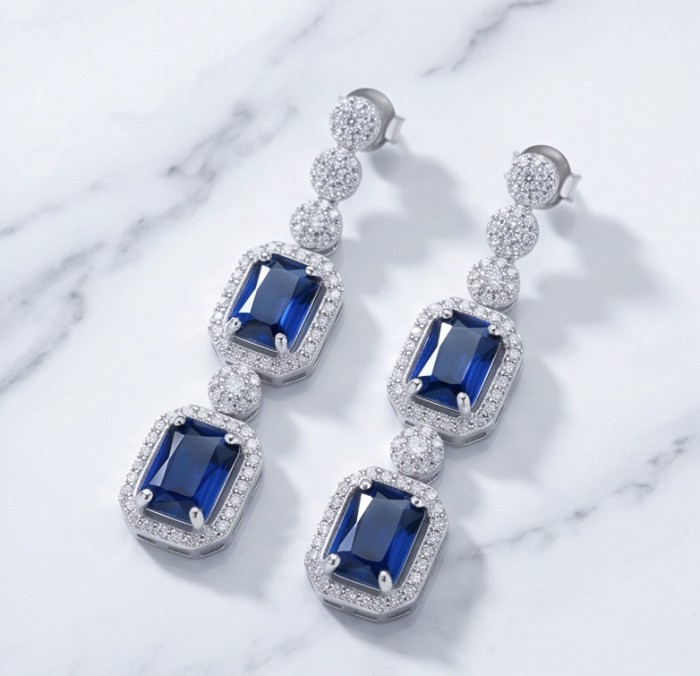Ofelia - Authentic 8.7 CARAT natural Sapphire .925 Sterling Silver handcrafted .925 Sterling Silver handmade Statement earrings - Elegant sapphire and diamond earrings on marble background, top view.