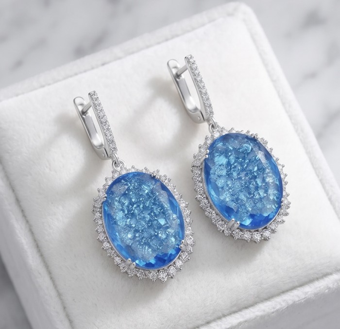 Angelina 14.9 carat authentic Swiss Blue Topaz .925 Sterling Silver Handcrafted Earrings - Close-up of blue topaz earrings with sterling silver settings.