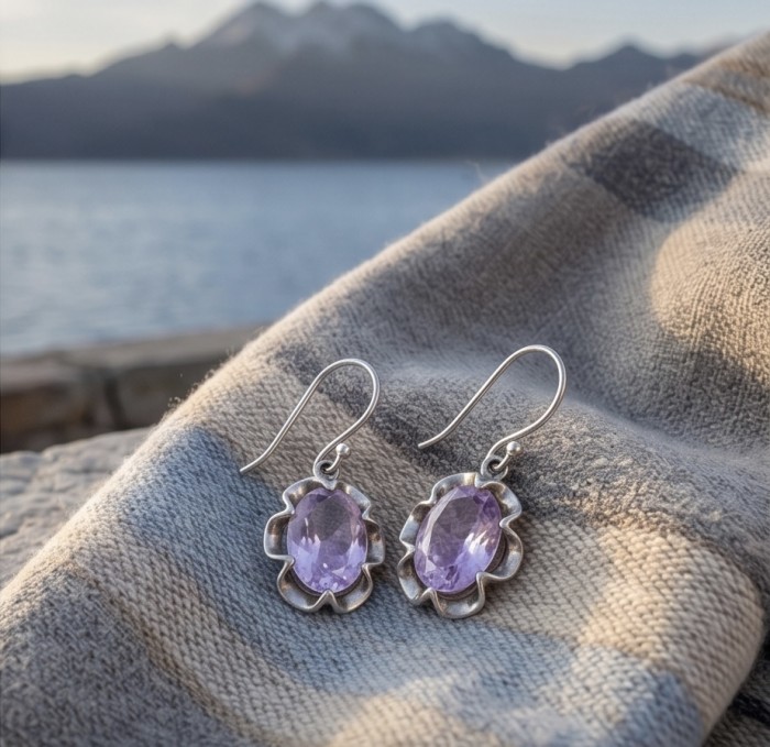 Norwegian Pink Fiord Quartz .925 Sterling Silver earrings - Side view of pink quartz sterling silver earrings on fabric.