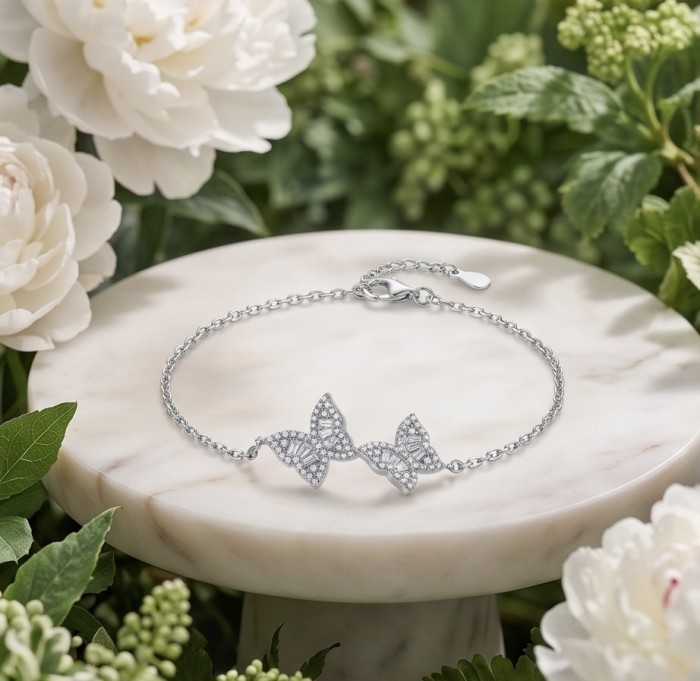 Two white Butterflies natural 7.5 carat White Topaz .925 Sterling Silver handmade Statement Bracelet - Silver butterfly bracelet on marble slab surrounded by flowers