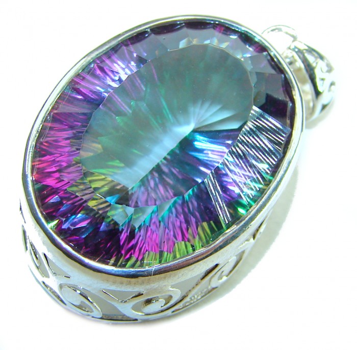 Blue Wonderland 49.7 carat oval cut Mystic Aurora Topaz .925 Sterling Silver handcrafted Pendant - Close-up of oval Mystic Aurora Topaz pendant with intricate silver setting.