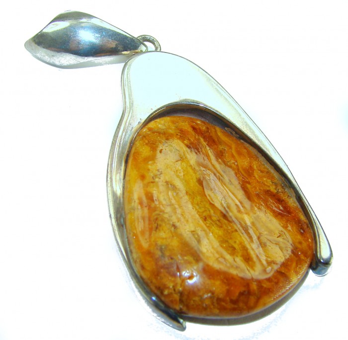 Sea Treasure Prehistoric Authentic Butterscotch Baltic Amber .925 Sterling Silver beautifully handcrafted Pendant - Side view of a Butterscotch Baltic Amber pendant with silver setting.