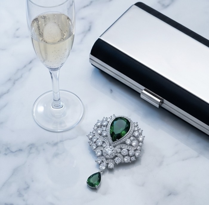 Heirloom Genuine 18.5 carat Colombian Emerald .925 Sterling Silver handmade Pendant - Brooch - Jewelry with emerald and diamonds on a marble table with glass and clutch.