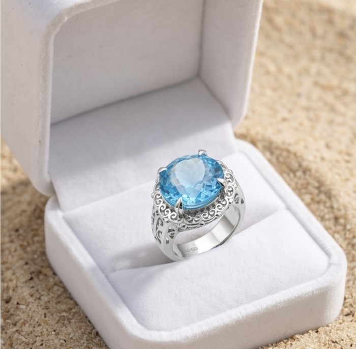Poseidon 18.8 carat Swiss Blue Topaz .925 Sterling Silver dipped in rhodium handcrafted Large ring size 8 1/4 - Blue topaz sterling silver ring in box, top view on sand background.