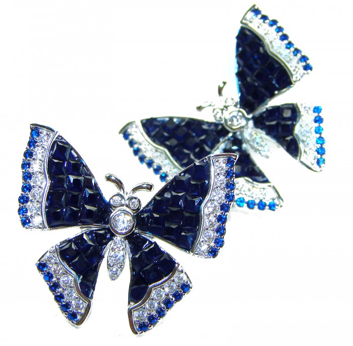 Magnificent Jewel Sapphire Butterflies .925 Sterling Silver handcrafted incredible earrings - Close-up of sapphire butterfly brooches on white background