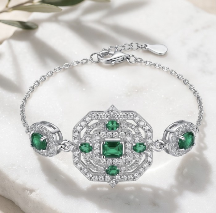 Art Deco - Pacifica - 4.4 carat Emerald .925 Sterling Silver handmade Statement Bracelet - Art Deco bracelet with emeralds, front view on marble surface