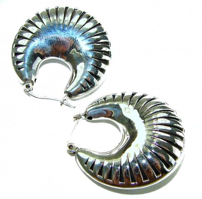 Highly Polished Fancy Modern design .925 Sterling Silver Italy made Earrings - Silver earrings with reflective finish, top view.