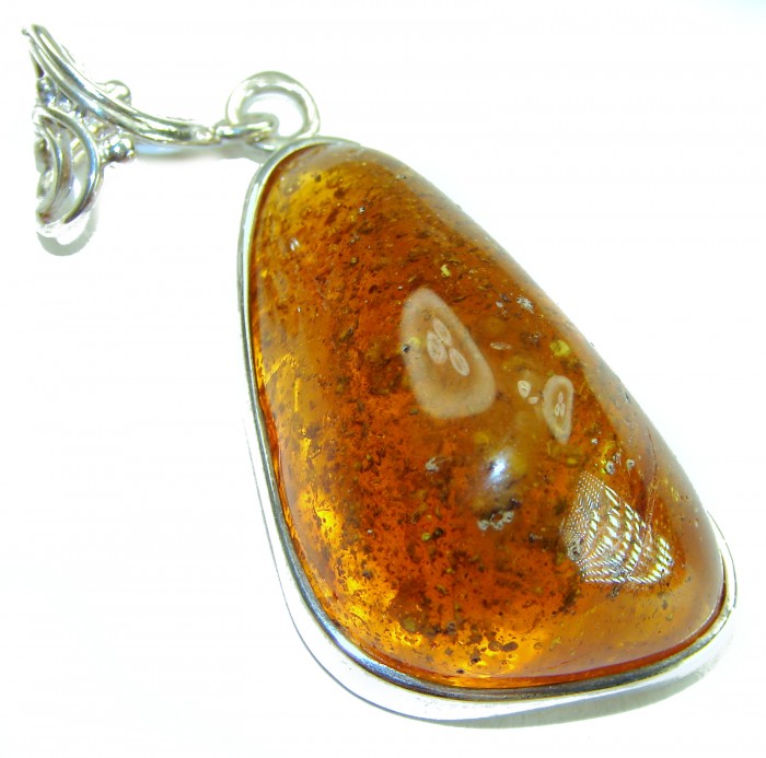 Prehistoric Authentic Golden Baltic Amber .925 Sterling Silver beautifully handcrafted Pendant - Close-up of amber pendant with silver setting and intricate bail detail.