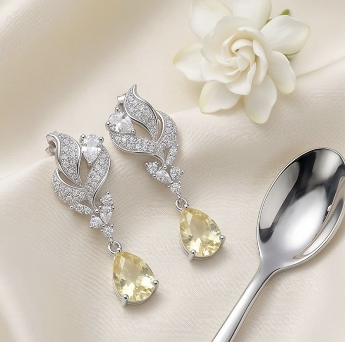 Luxurious 4.5 carat Golden - yellow Montana Sapphire .925 Sterling Silver handcrafted earrings - Elegant drop earrings with yellow sapphires on a satin background.
