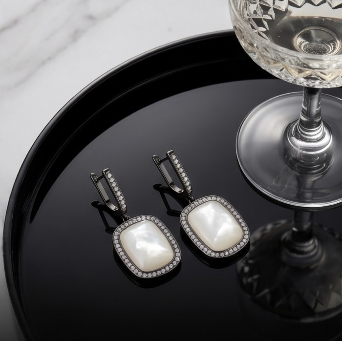 Top quality Sublime Blister Pearl black rhodium over .925 Sterling Silver handcrafted Earrings - Earrings on black tray with glass, showcasing pearl and diamond design.
