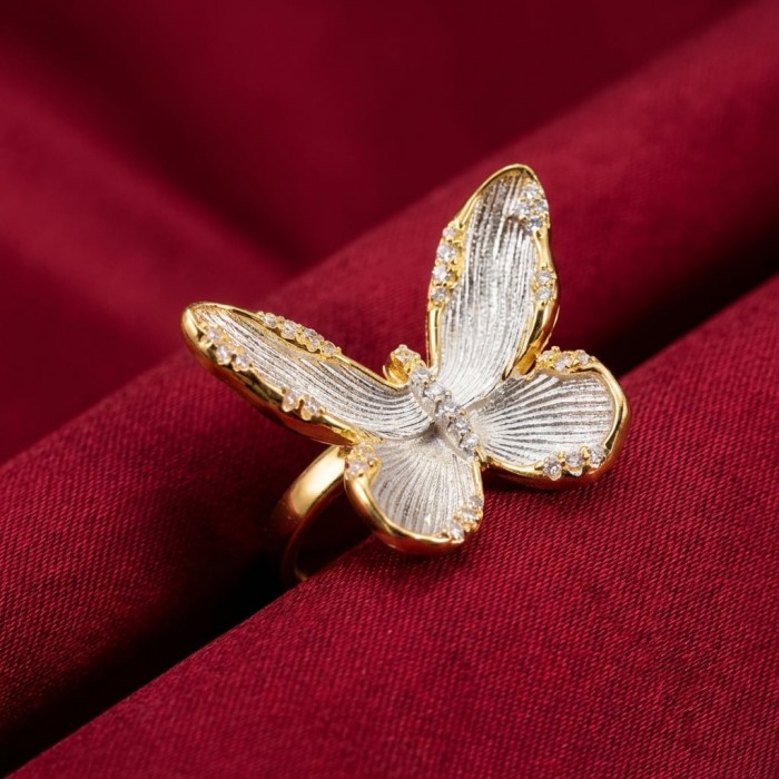 Golden Butterfly White Topaz highly polished 18K Gold over .925 Sterling Silver Italy made ring s. 8 - Butterfly ring on red fabric, top view, gold with white topaz accents.