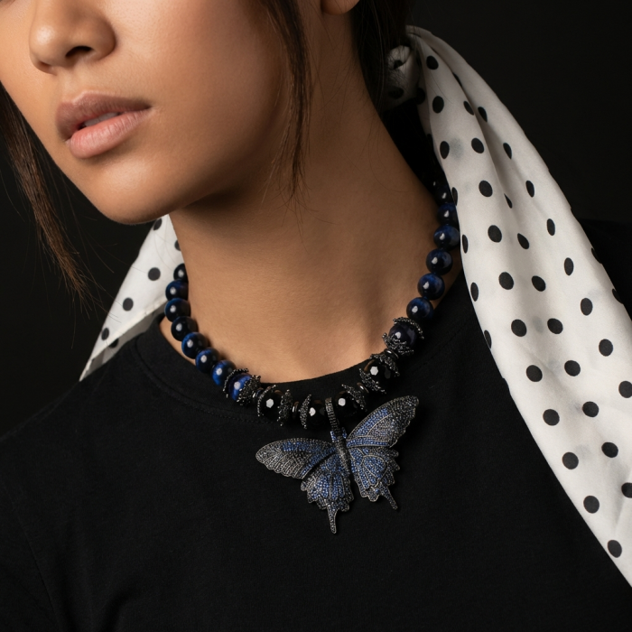 101.8 grams Blue Butterfly Rare Unusual Deep Blue Cats Eys Beads black rhodium over .925 Sterling Silver NECKLACE - Necklace with blue butterfly pendant worn around neck, side view.