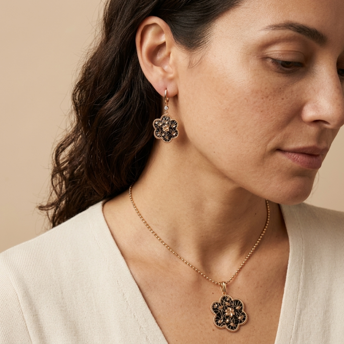 Dubai Style - Golden Flowers black enamel .925 Sterling Silver dipped in 22K Rose Gold handmade Pendant - Side view of woman wearing golden flower earring and necklace set.