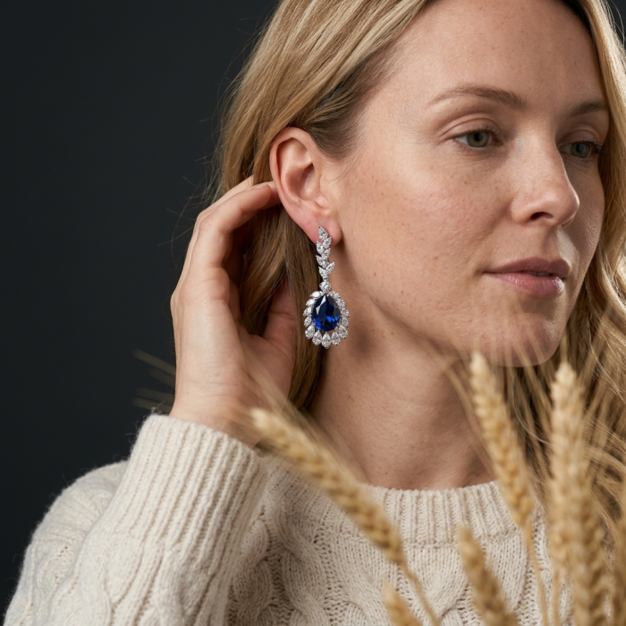 Giovanna - Authentic pear cut 22.9 carat Sapphire .925 Sterling Silver handcrafted earrings - Woman wearing a pear-cut sapphire earring, side view.