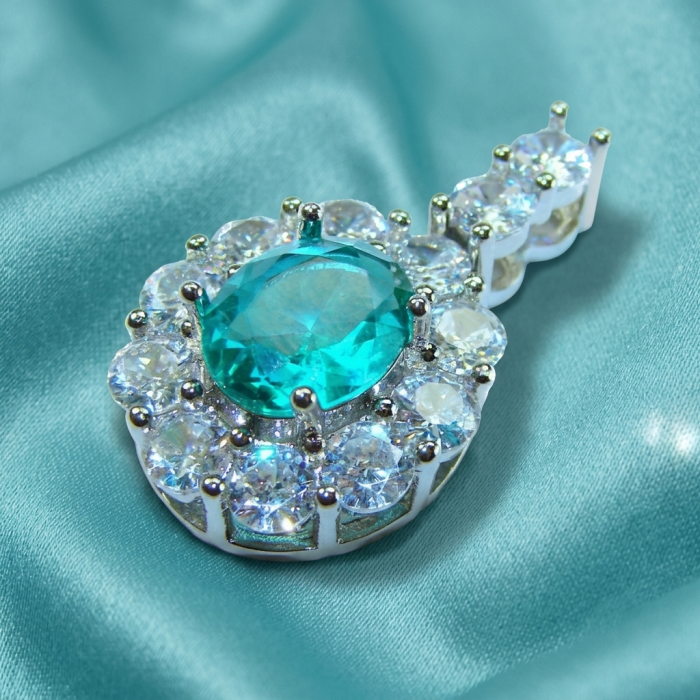 Divine Beauty 8.5 carat Aquamarine .925 Sterling Silver handcrafted pendant - Aquamarine pendant close-up on teal fabric.