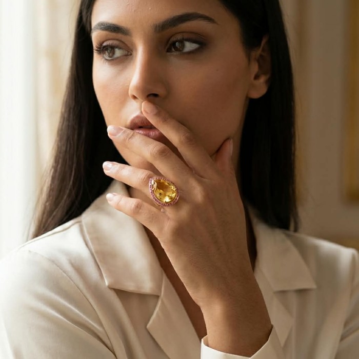 Vivien - Natural 25.8 carat pear cut BRAZILIAN Citrine .925 Sterling Silver dipped in 22K Gold handmade Statement Ring size 7 1/4 - Woman wearing Vivien ring with Brazilian Citrine, hand near face.