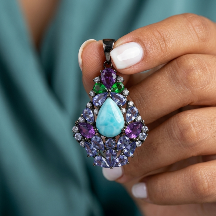 Victoria Natural 4.5 carat Larimar from Dominican Republic Tanzanite .925 Sterling Silver dipped in black rhodium handcrafted pendant - Close-up of Larimar pendant with multicolored gemstones held in hand.