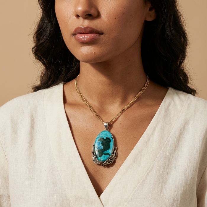 Colors of the Earth Authentic Chrysocolla .925 Sterling Silver handcrafted Large Pendant - Chrysocolla pendant on model, front view, cream blouse background.