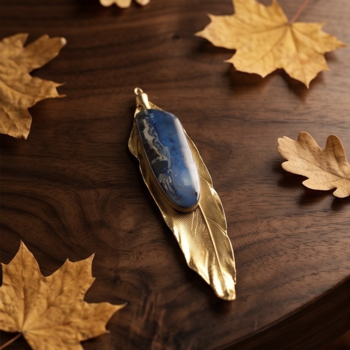 Stylish REAL Leaf dipped in gold Boulder Opal .925 Sterling Silver Pendant - Gold-dipped leaf pendant with opal on wood, surrounded by autumn leaves.