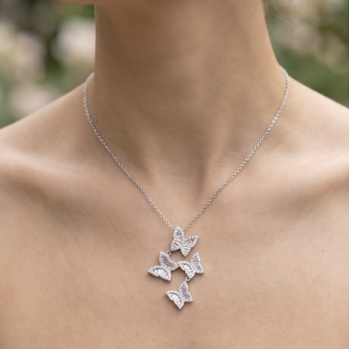 Four Butterflies natural 7.5 carat White Topaz .925 Sterling Silver handmade Statement necklace - Necklace with four butterfly pendants worn around the neck.