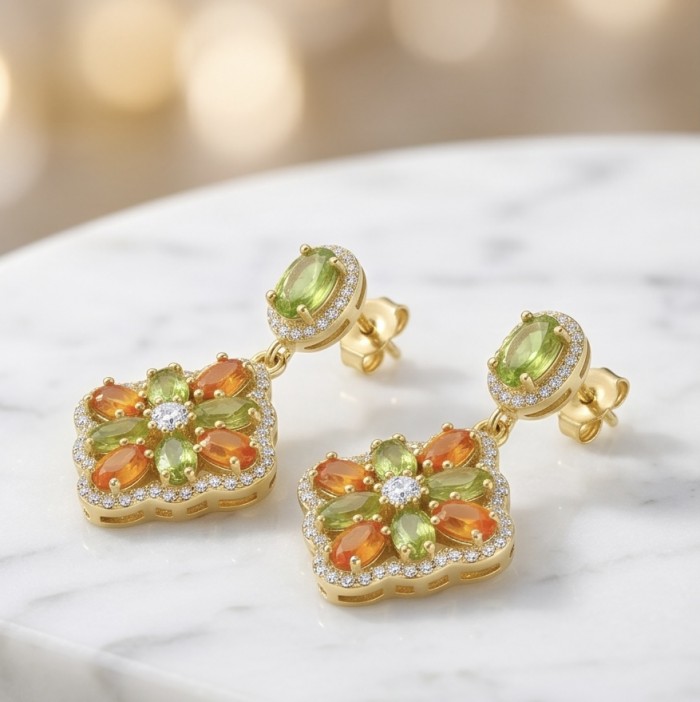 Giovanna - Genuine 4.6 carat orange Sapphire 22K Gold over .925 Sterling Silver handcrafted Statement Earrings - Elegant earrings with orange sapphires and 22K gold, close-up on marble.