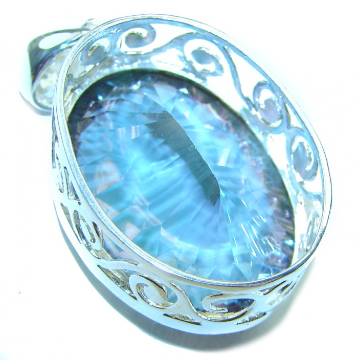Blue Wonderland 49.7 carat oval cut Mystic Aurora Topaz .925 Sterling Silver handcrafted Pendant - Close-up of blue Mystic Aurora Topaz pendant with ornate setting.