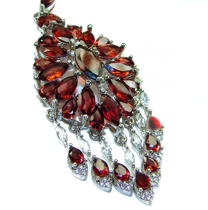 Red Royalty Authentic 185.5 carat authentic Tanzania Garnet .925 Sterling Silver brilliantly handcrafted necklace - Close-up of red garnet pendant with silver accents.